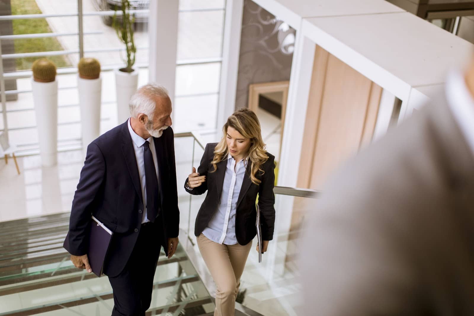 Professional coworkers taking the stairs at their office.