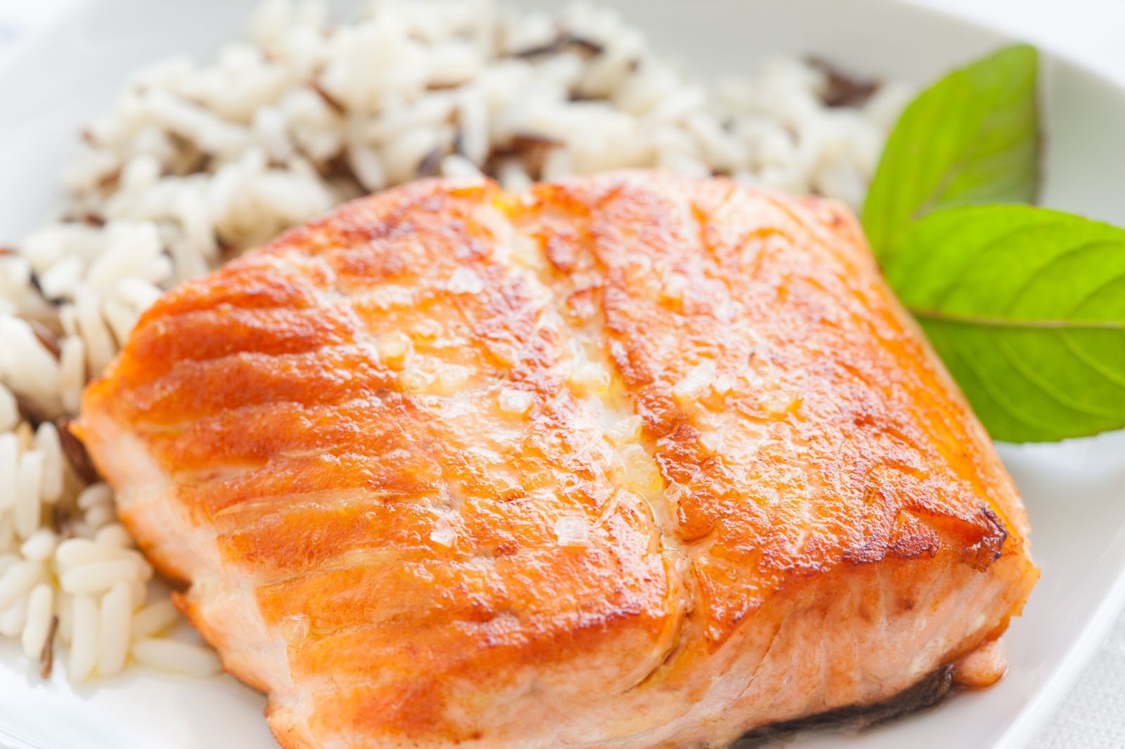 Grilled Salmon on a plate next to rice pilaf