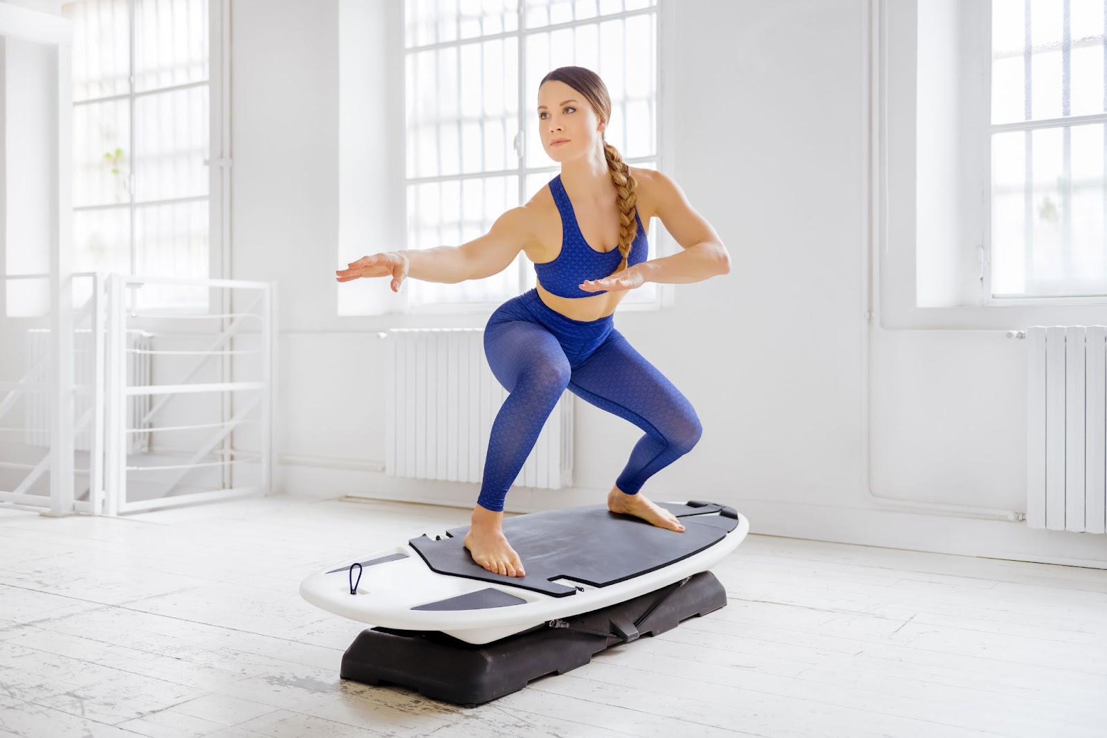 Woman performing a surfer squat