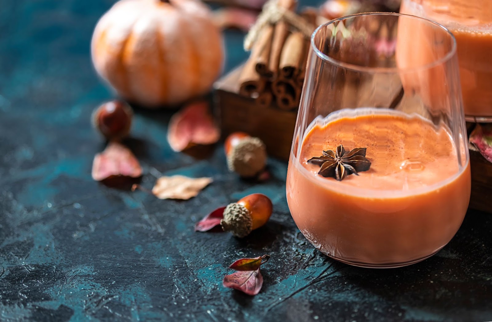 Autumn cocktail drink with pumpkin and anise seed on top