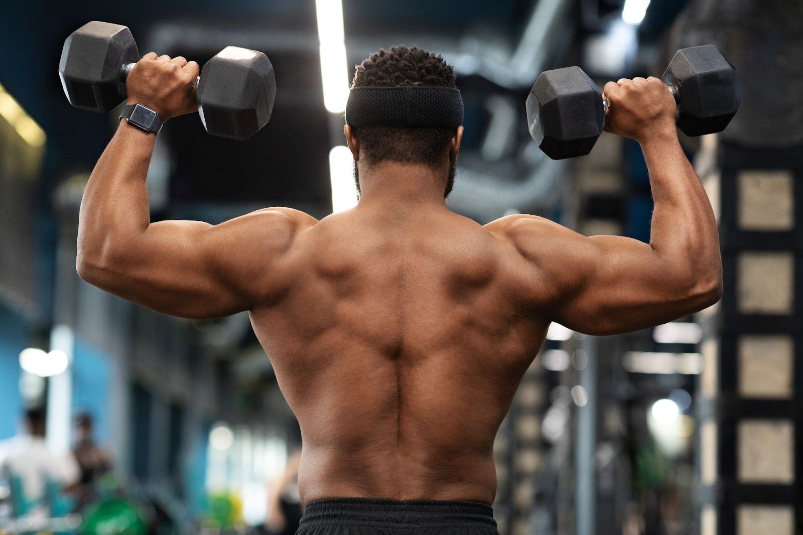 Strong, muscular man working out his rhomboid muscles at the gym