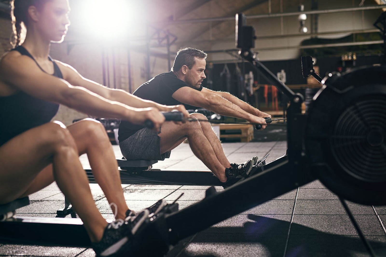 Indoor rowing class featuring a man and a woman