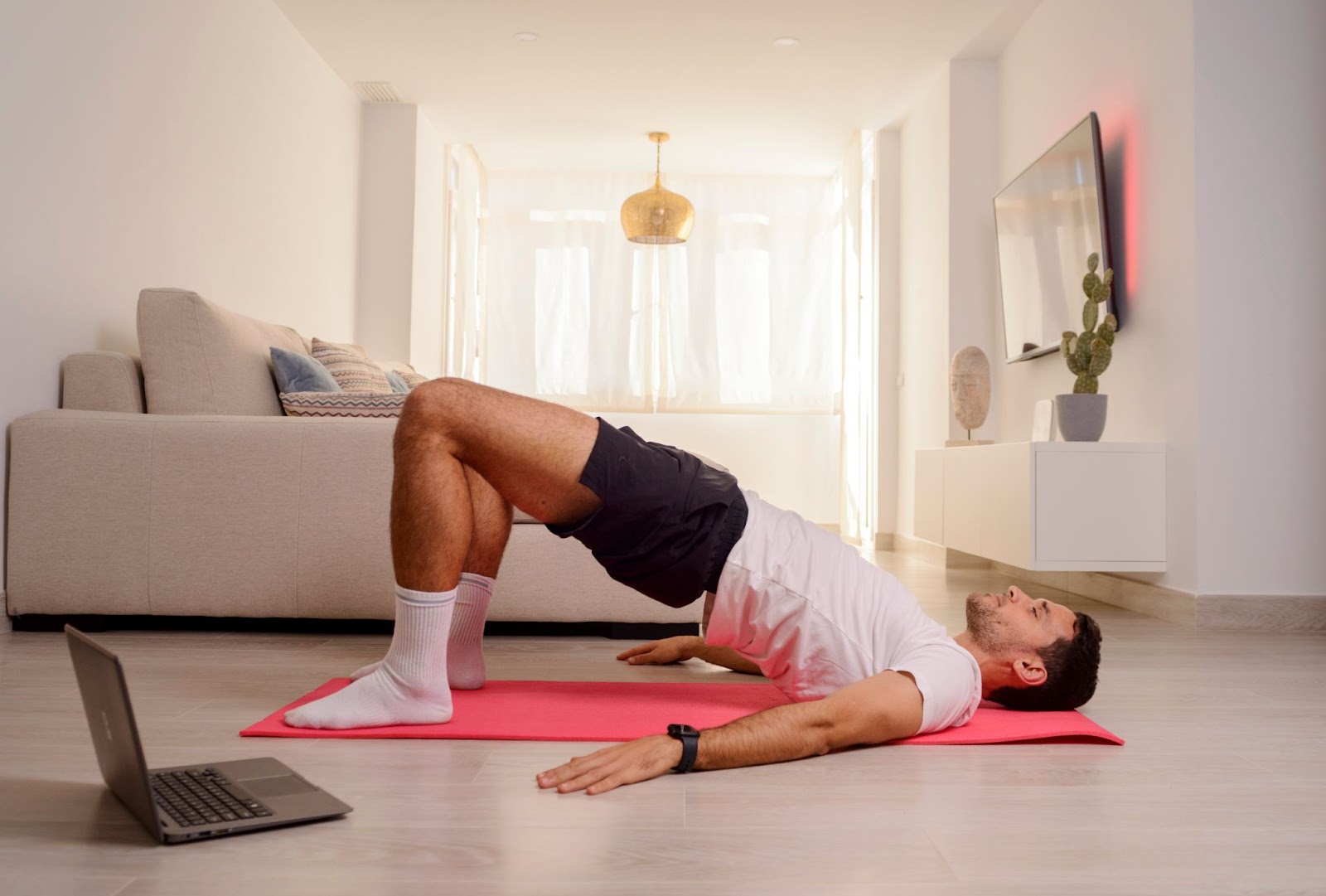 Man performing a glute bridge at home