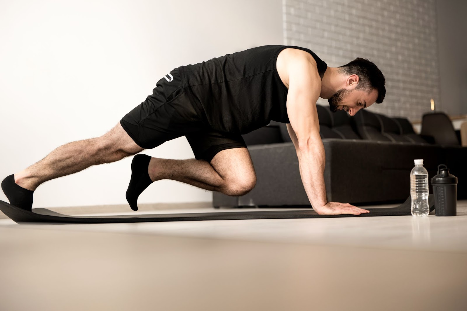 Man performing a slow mountain climber at home