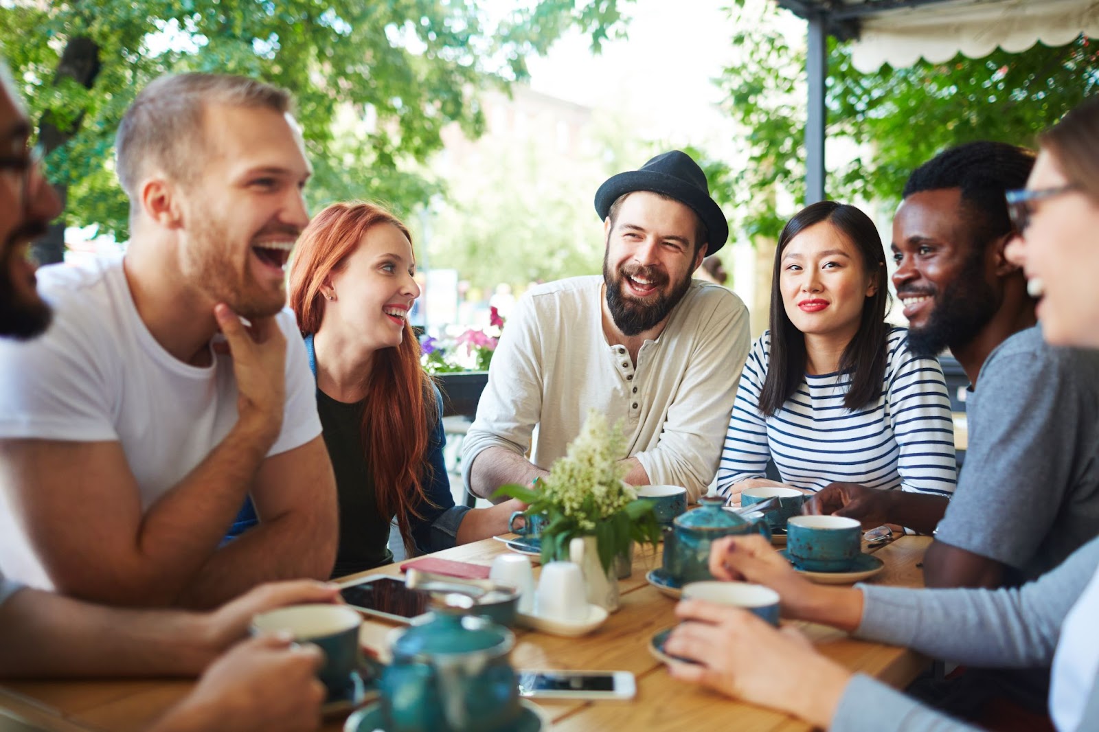 Large group of friends drinking tea at a cafe