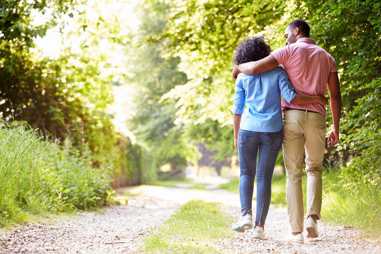 Couple walking on a lush and pretty dirt road