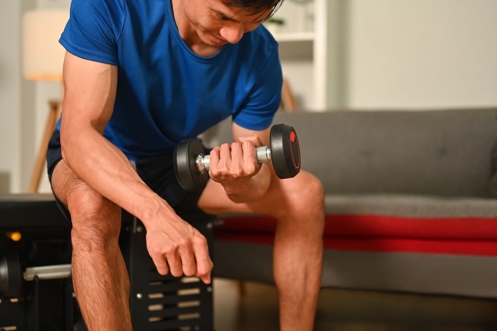 Man lifting lightweight dumbbells at home