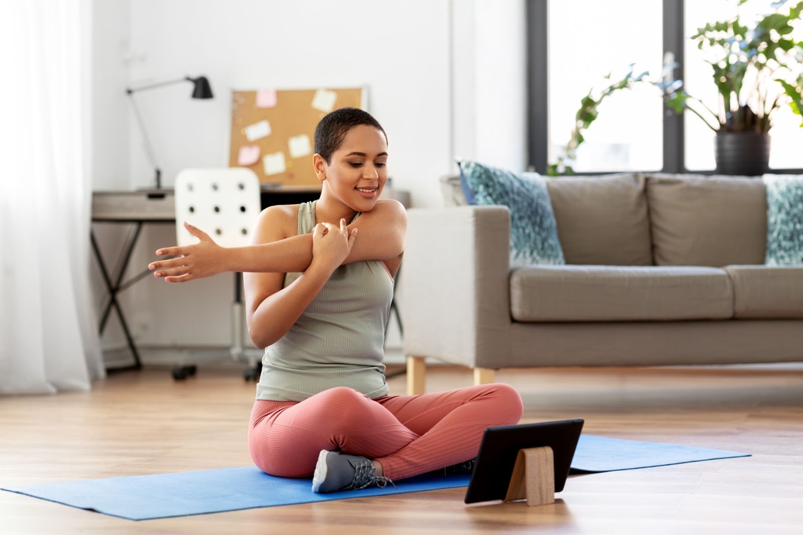 Young fit woman stretching at home