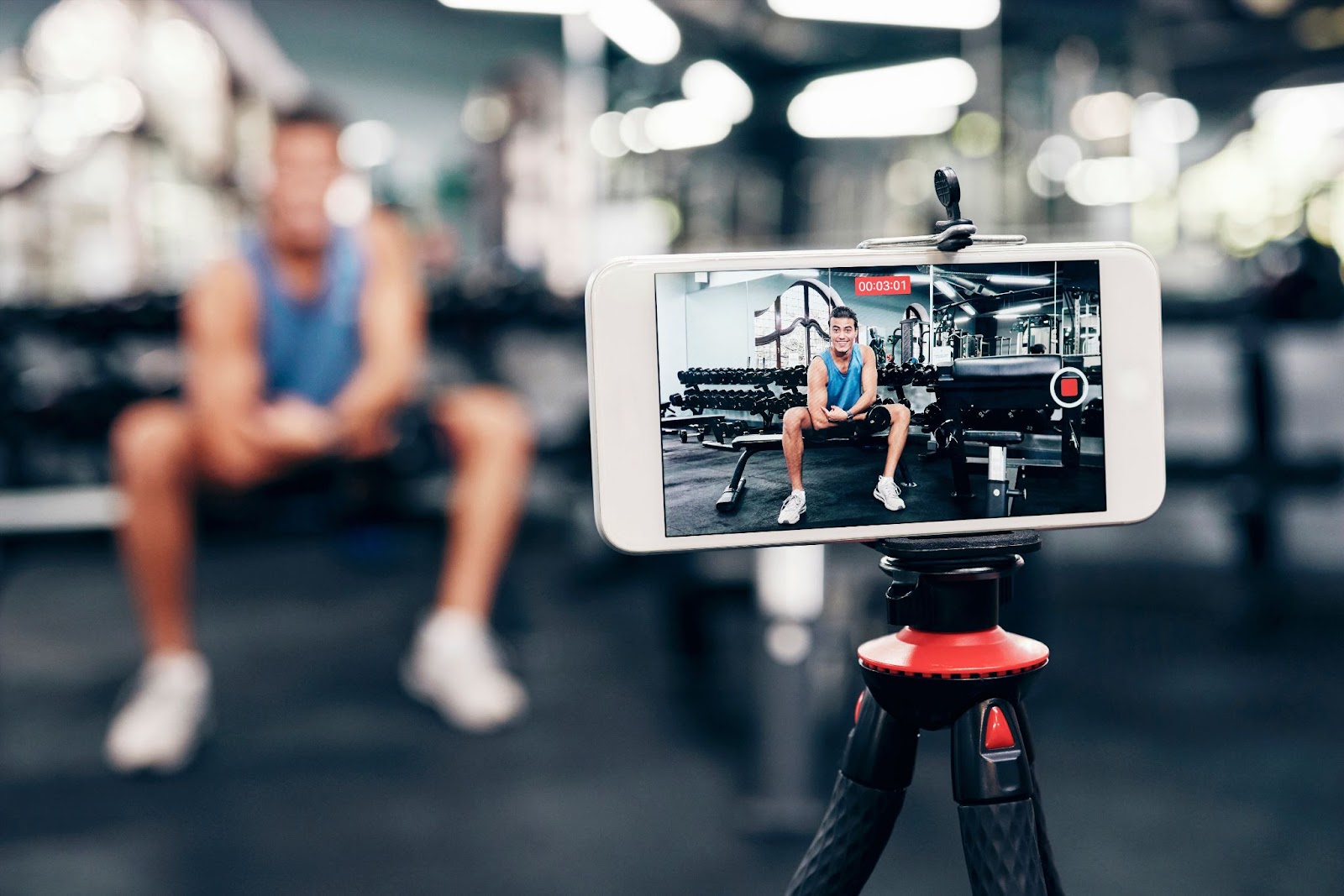 Fitness influencer recording a video at a gym