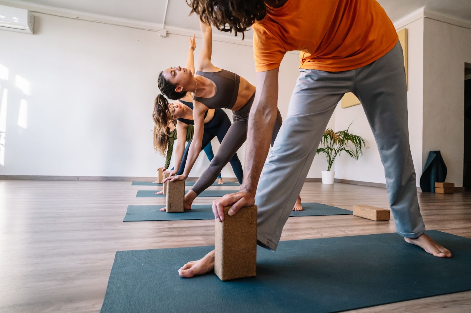Yoga studio with four members using yoga blocks