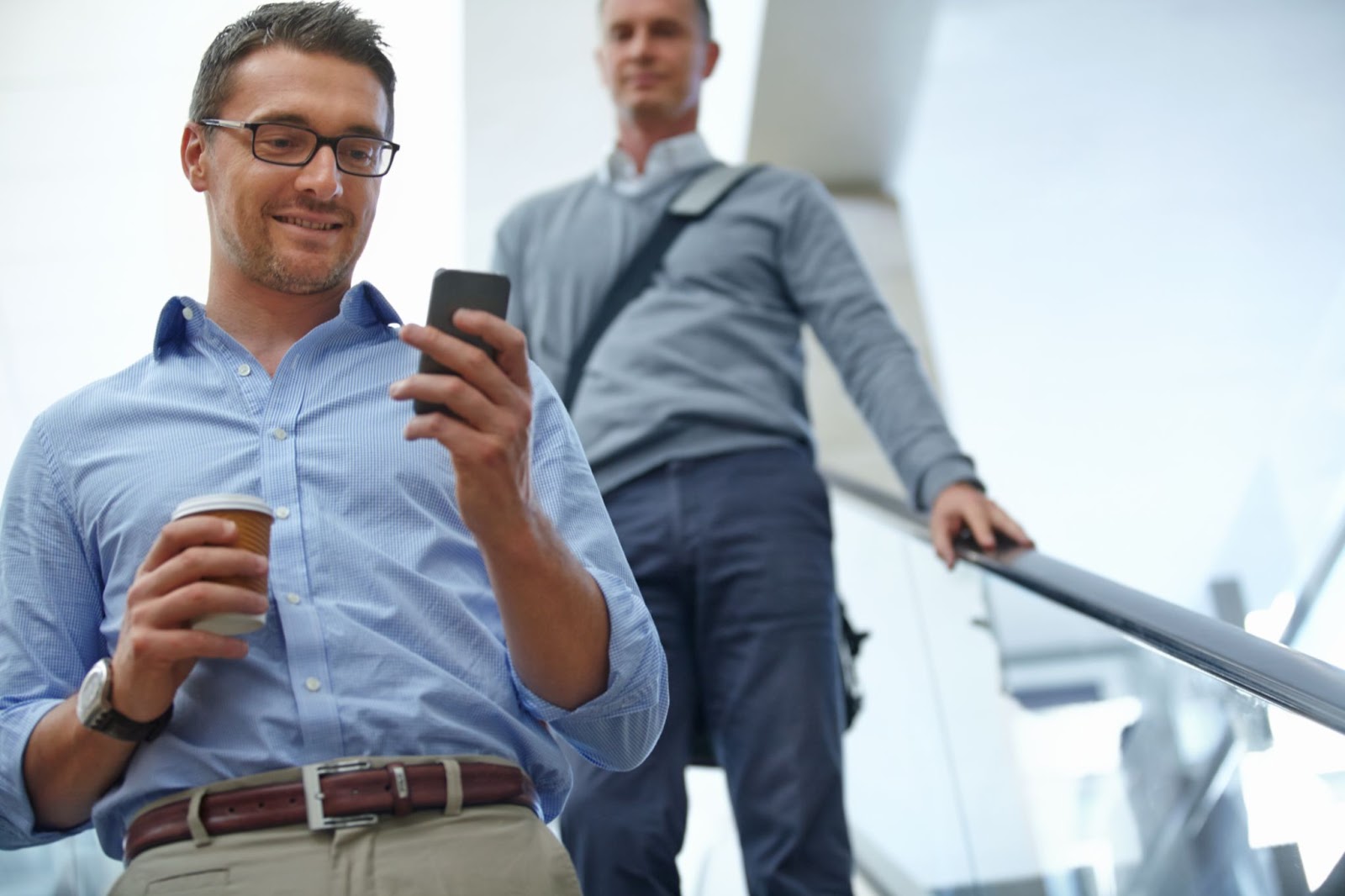 Two businessmen using the stairs at their office