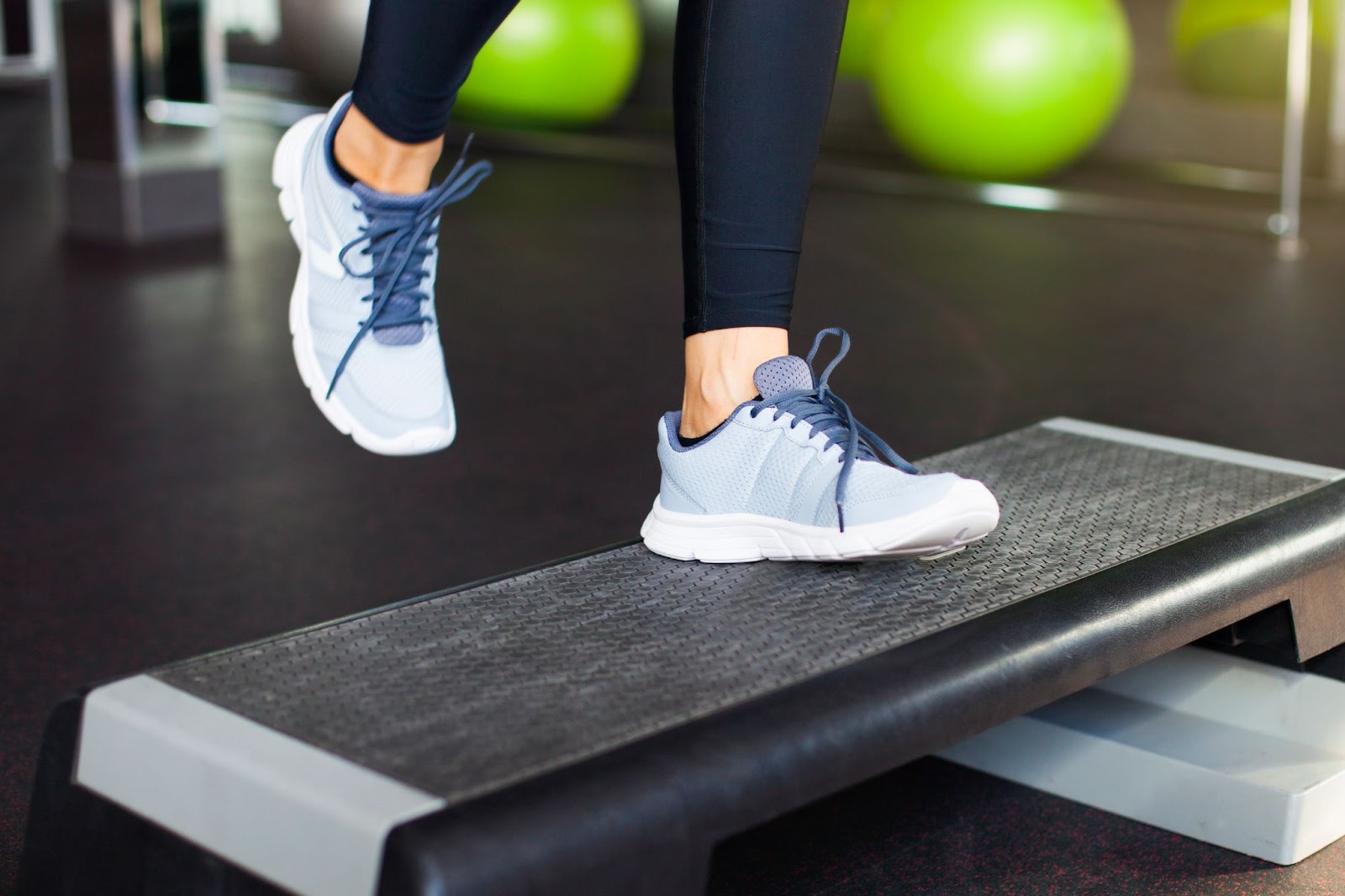 Closeup shot of a woman performing a step-up exercise