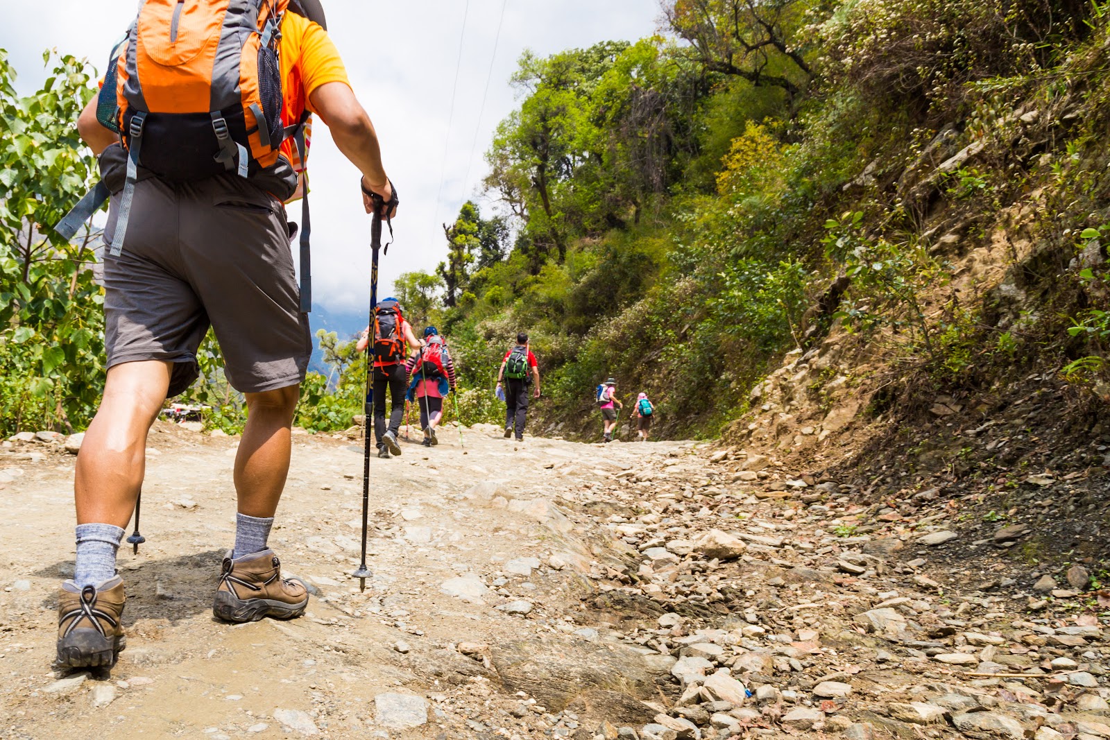 Fit man with strong calf muscles going for a hike up a mountain