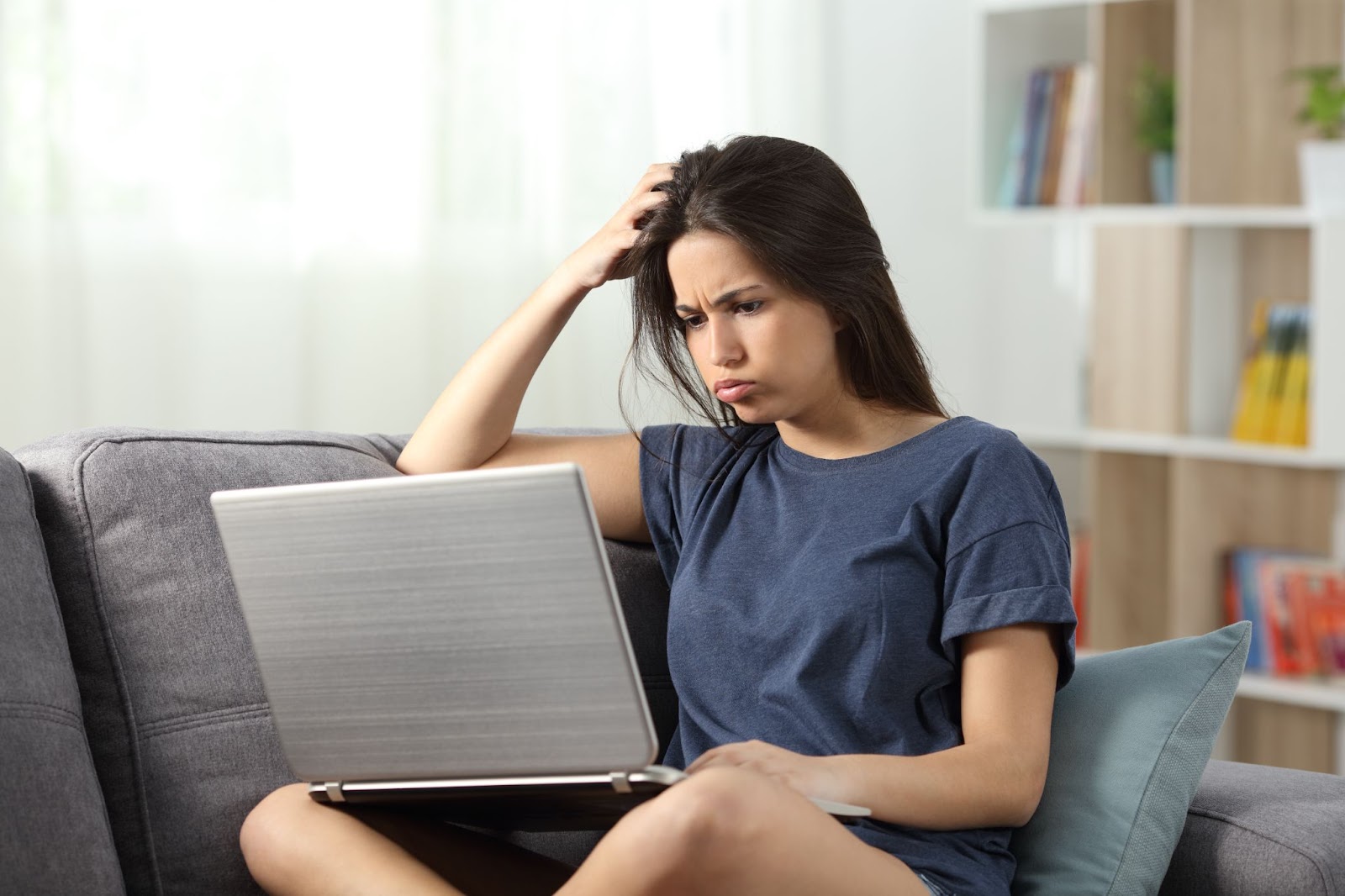 Woman searching on the internet, looking frustrated