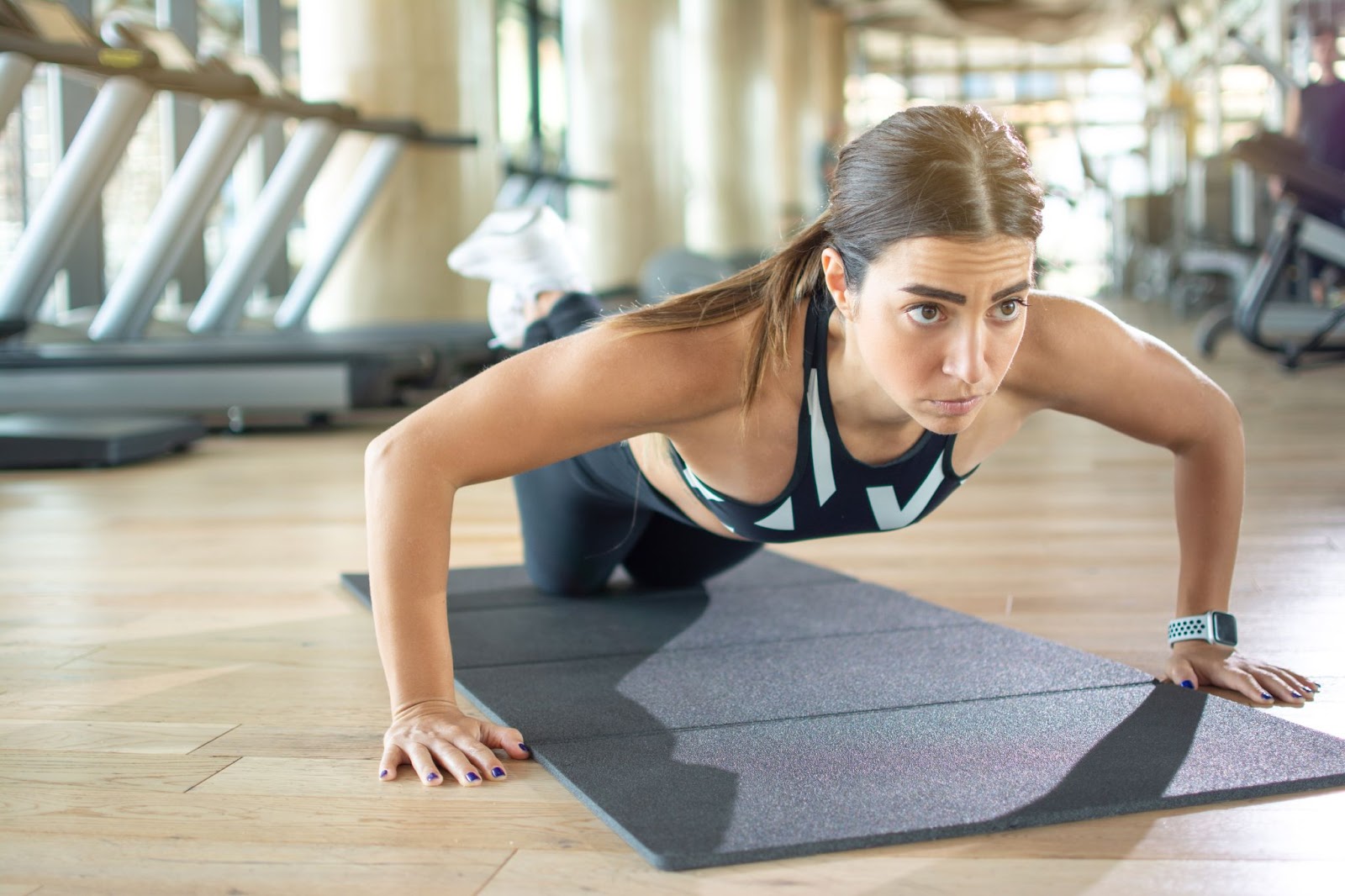 Fit woman performing a knee plank