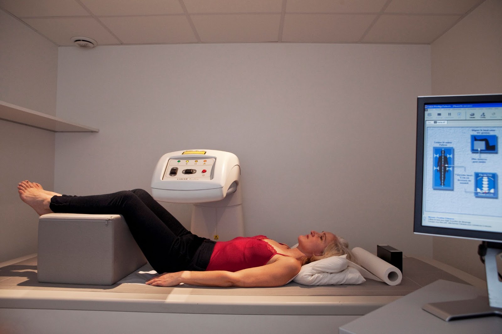 Older woman sitting in a DEXA scan machine
