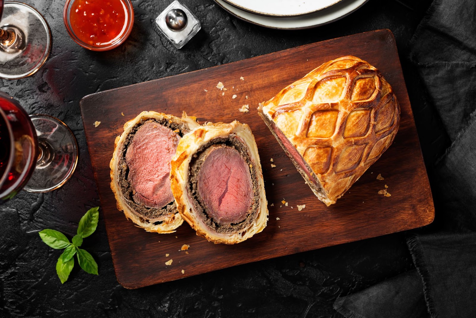 Thanksgiving beef wellington atop a wood block meal
