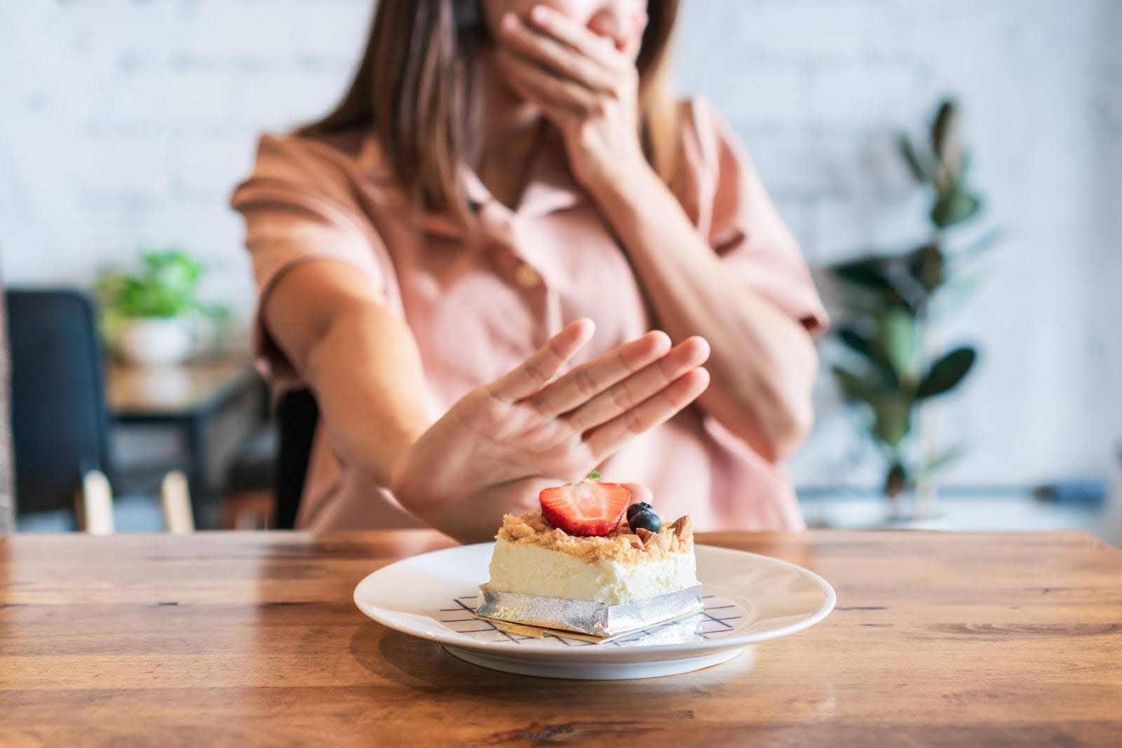 A person saying no to a dessert