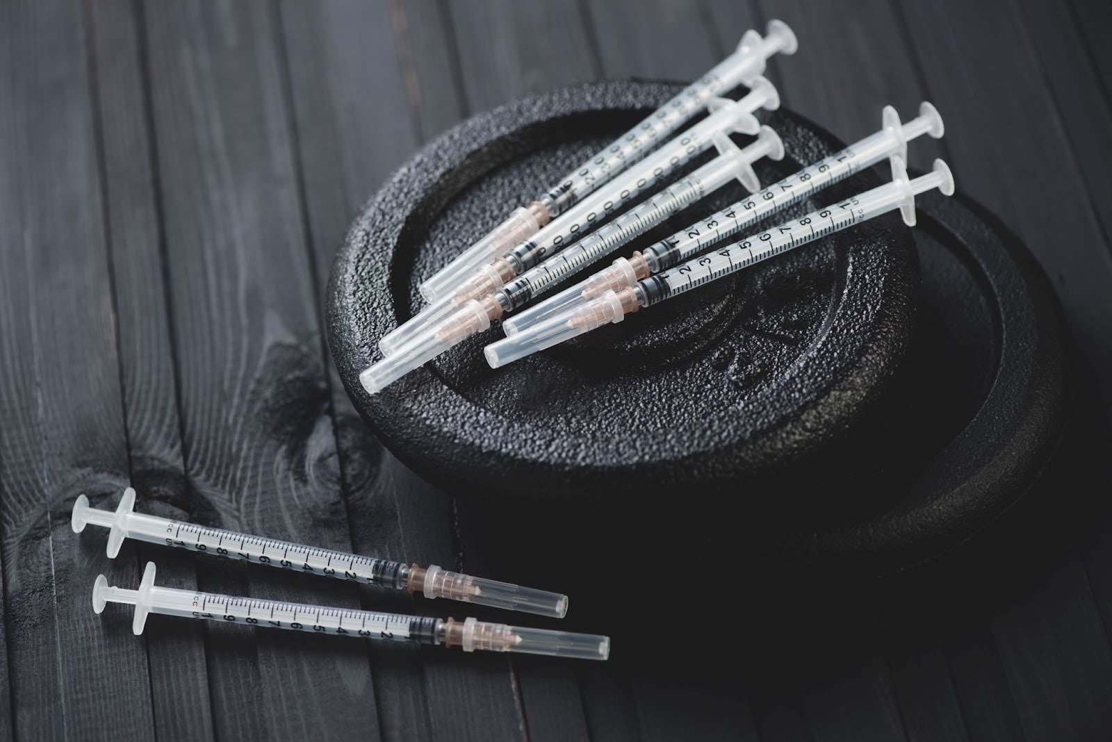 Needle syringes on top of weights in a fitness studio