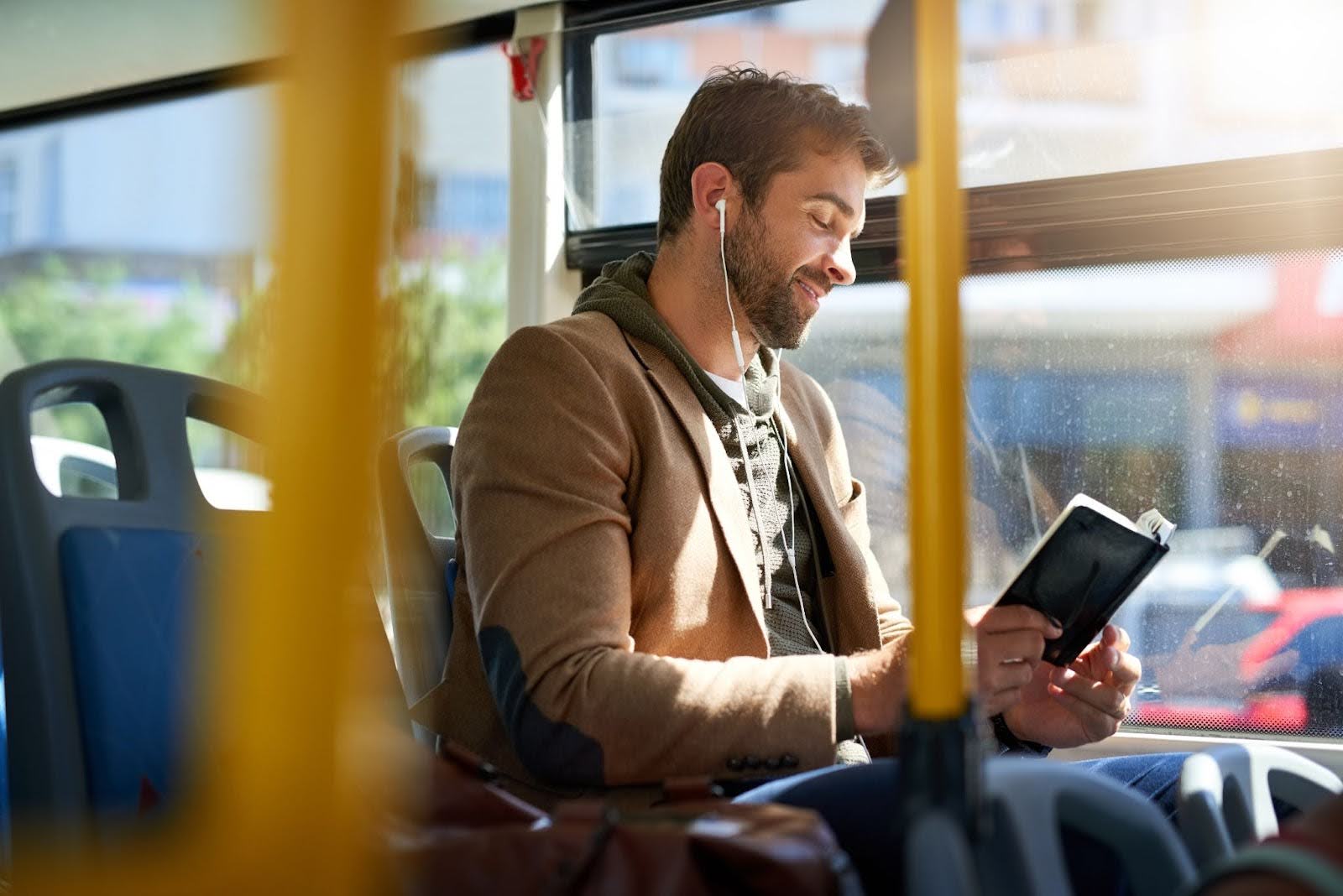 Man riding a bus around in a city