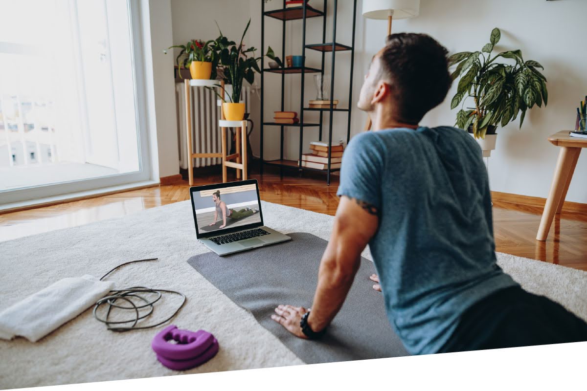 Person taking a Studio SWEAT onDemand yoga class at home