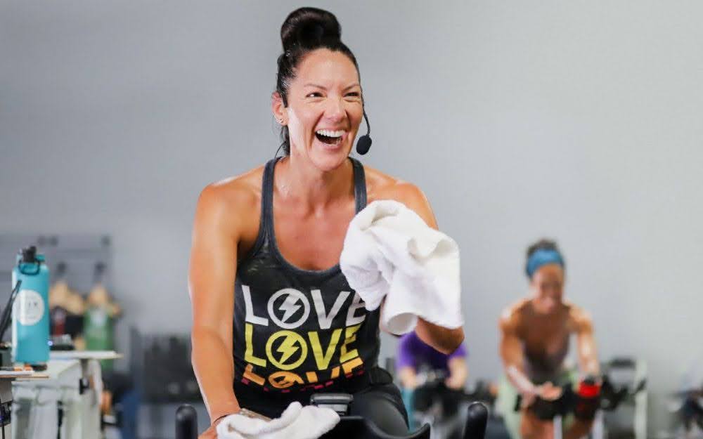 Studio SWEAT onDemand Trainer teaching a Spin class