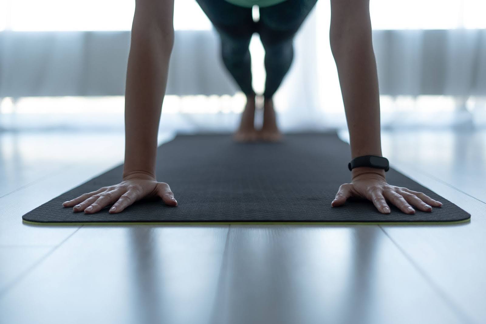 Closeup of woman doing Pilates on a mat