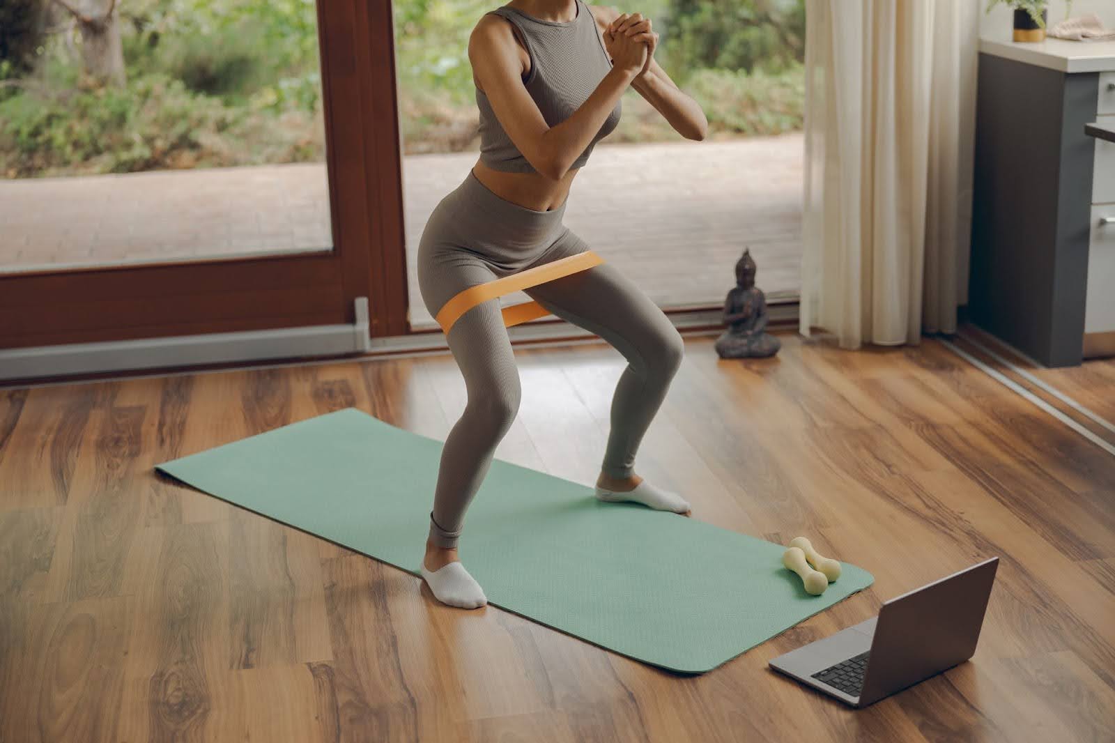 Person taking a Pilates class with a workout band